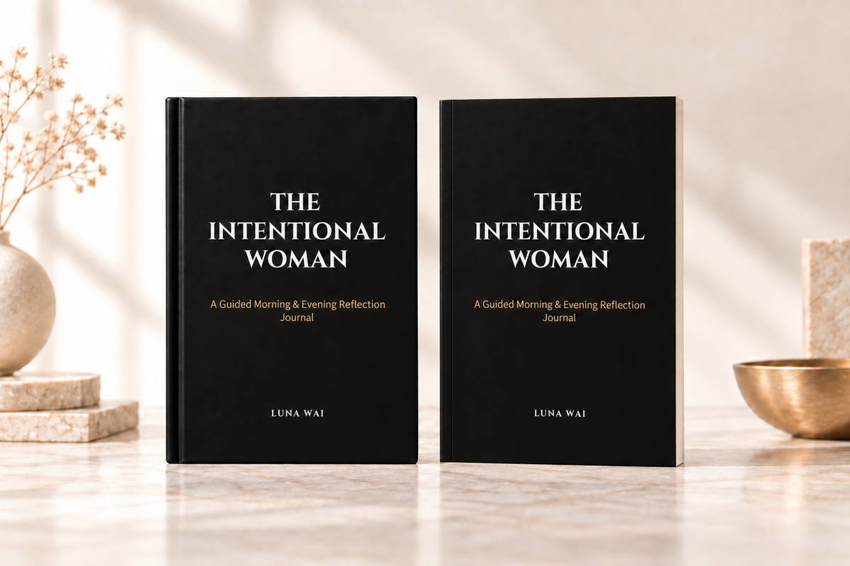 The Intentional Woman Black + Bronze paperback and hardcover journals on a warm cream background.